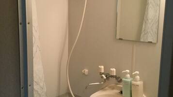 Separate tub and shower, hair dryer, slippers, towels