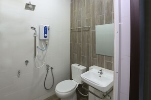 A bathroom with a toilet, a sink, a shower, and a hand dryer. - OYO 89859 PP Traveller's Hotel (Pasir Puteh)