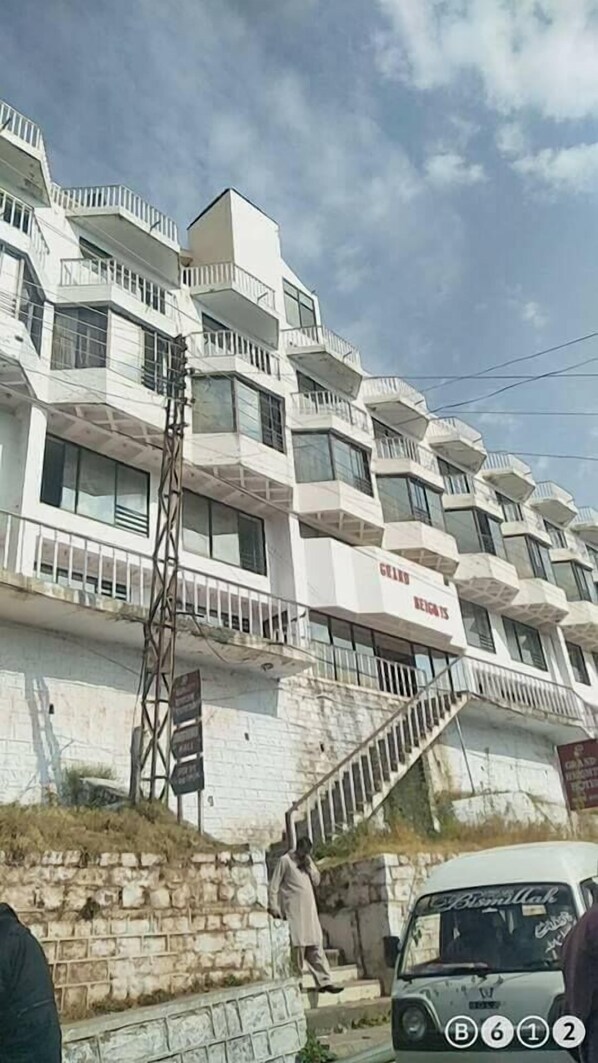 A multi-story building with balconies and a staircase leading to the entrance. - Grand Heights Hotel (Murree)