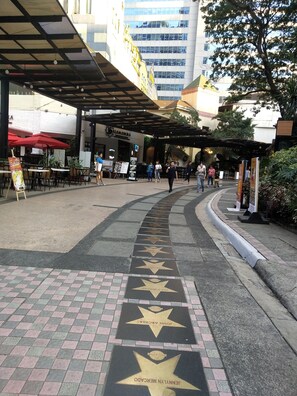 A walkway with star-shaped pavement leading to a building entrance. - One Eastwood Avenue (Quezon City)