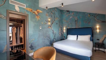 A bedroom with a large bed, a wardrobe, and a chair.