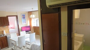 A compact living space with a dining area, kitchenette, and a bathroom. - Apartments Istarska - Adults Only (Split)