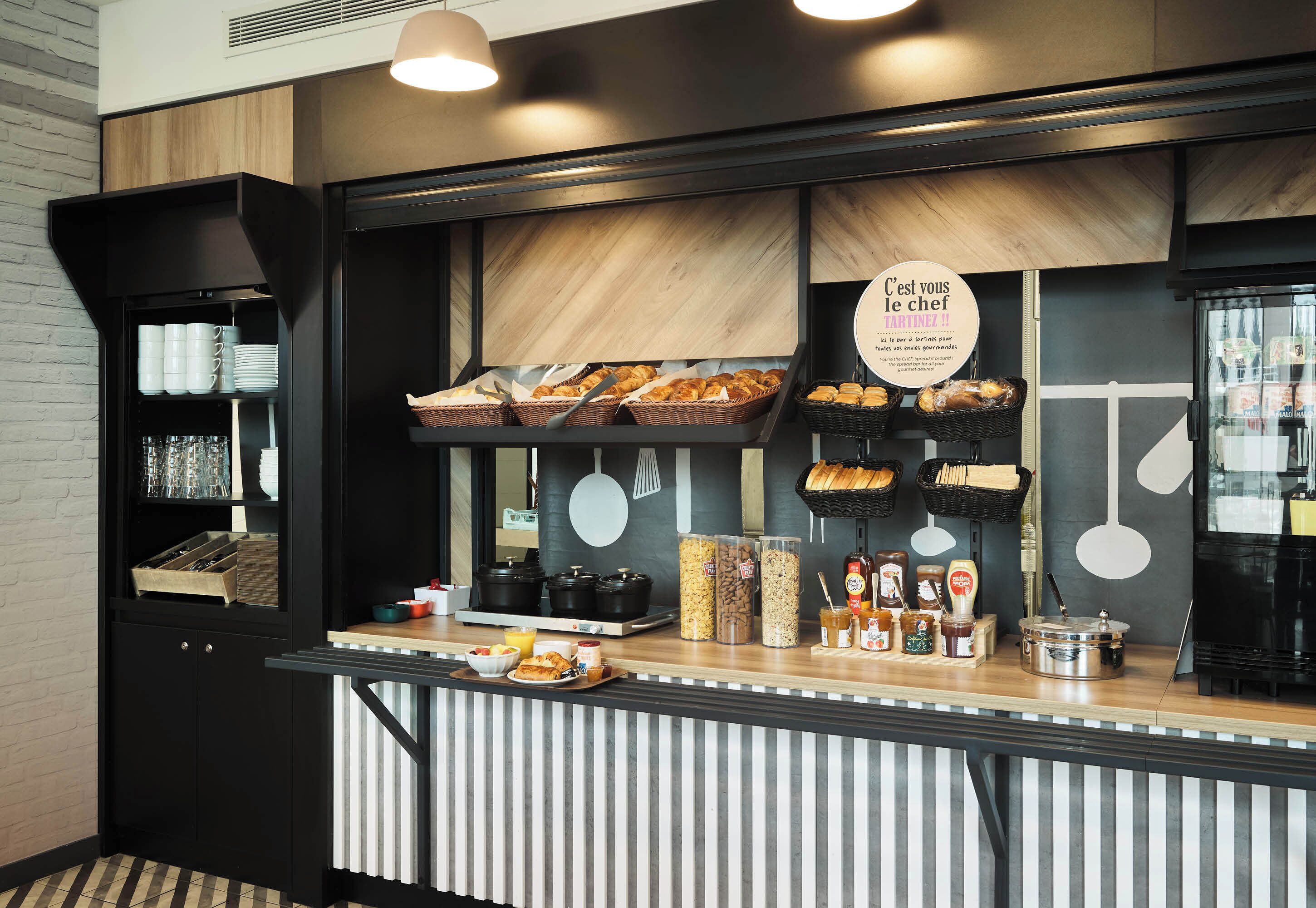 A breakfast bar with various food items and condiments.