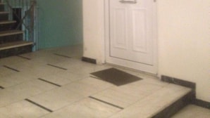 A staircase leading to a door with a doormat. - Elegant Apartment (Athens)