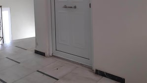 A white door with a handle and a small light fixture above it. - Elegant Apartment (Athens)