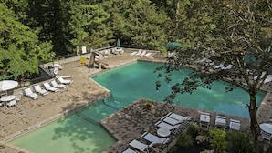 A pool area with multiple lounge chairs and a small hot tub. - Couples, Honeymoon, Anniversary Cabin, convenient to Gatlinburg, National Park (Gatlinburg)