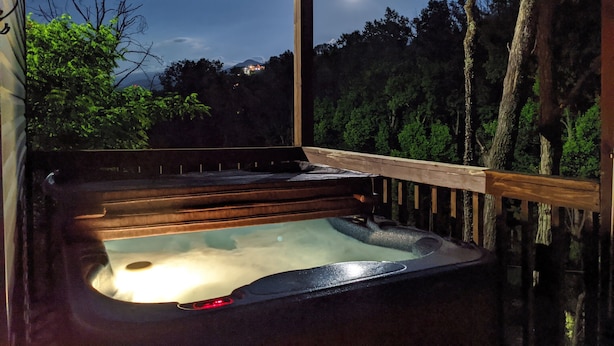 A hot tub under a wooden deck with a night sky view. - Couples, Honeymoon, Anniversary Cabin, convenient to Gatlinburg, National Park (Gatlinburg)