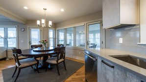 A modern kitchen with a central island, stainless steel appliances, and large windows. - Newly Constructed 3 Bedroom, 2 Bath Home on 12.5 Acres, Water Access and Views (WestBrook)