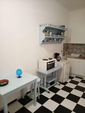 Kitchen area with a microwave, sink, and storage.