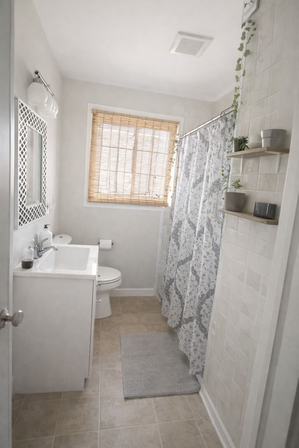 A bathroom with a toilet, sink, and shower area.