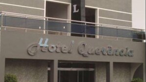 A hotel with a modern design, featuring a prominent vertical sign with the word "HOTEL" and a balcony on the upper floor. - Hotel Querência (Pitanga)