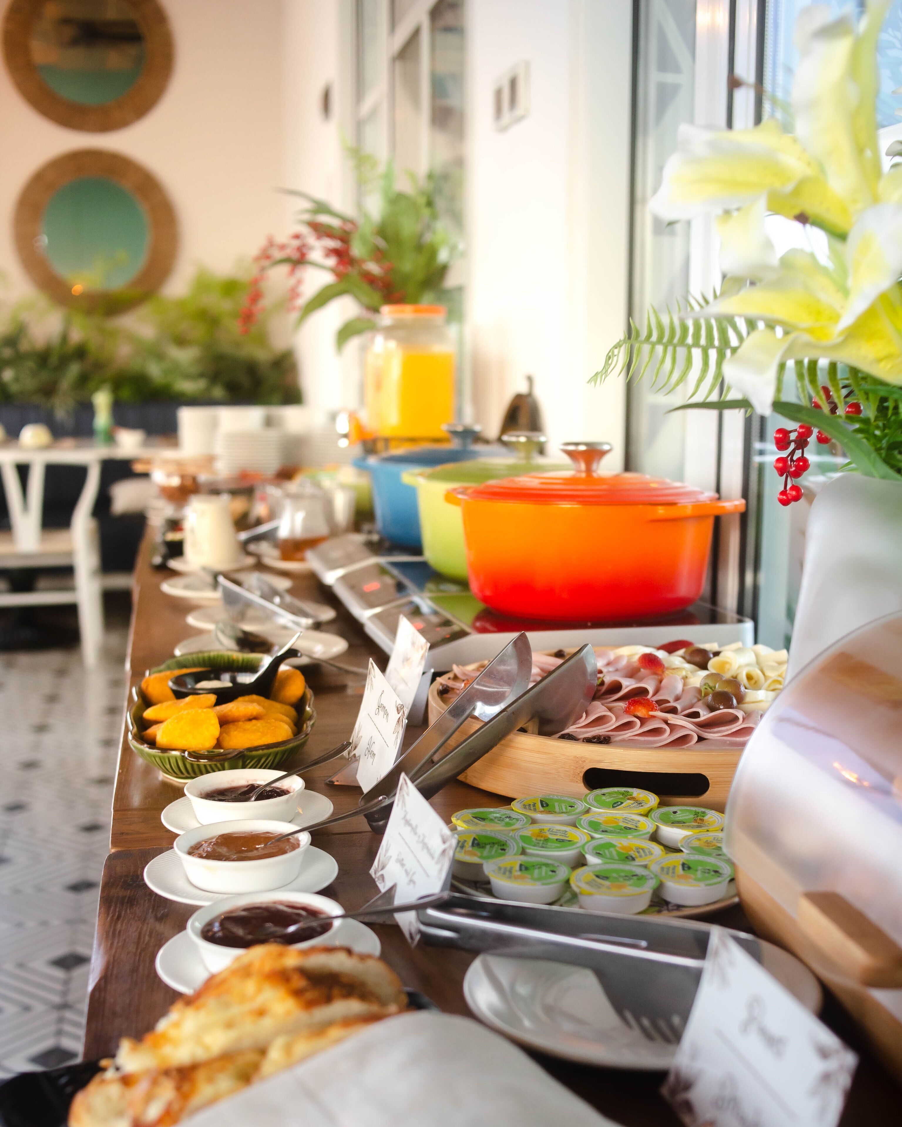 A buffet table with various food items and condiments.