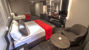 A hotel room with a bed, a desk, a chair, and a mirror. - Methis Hotel (Izmir)