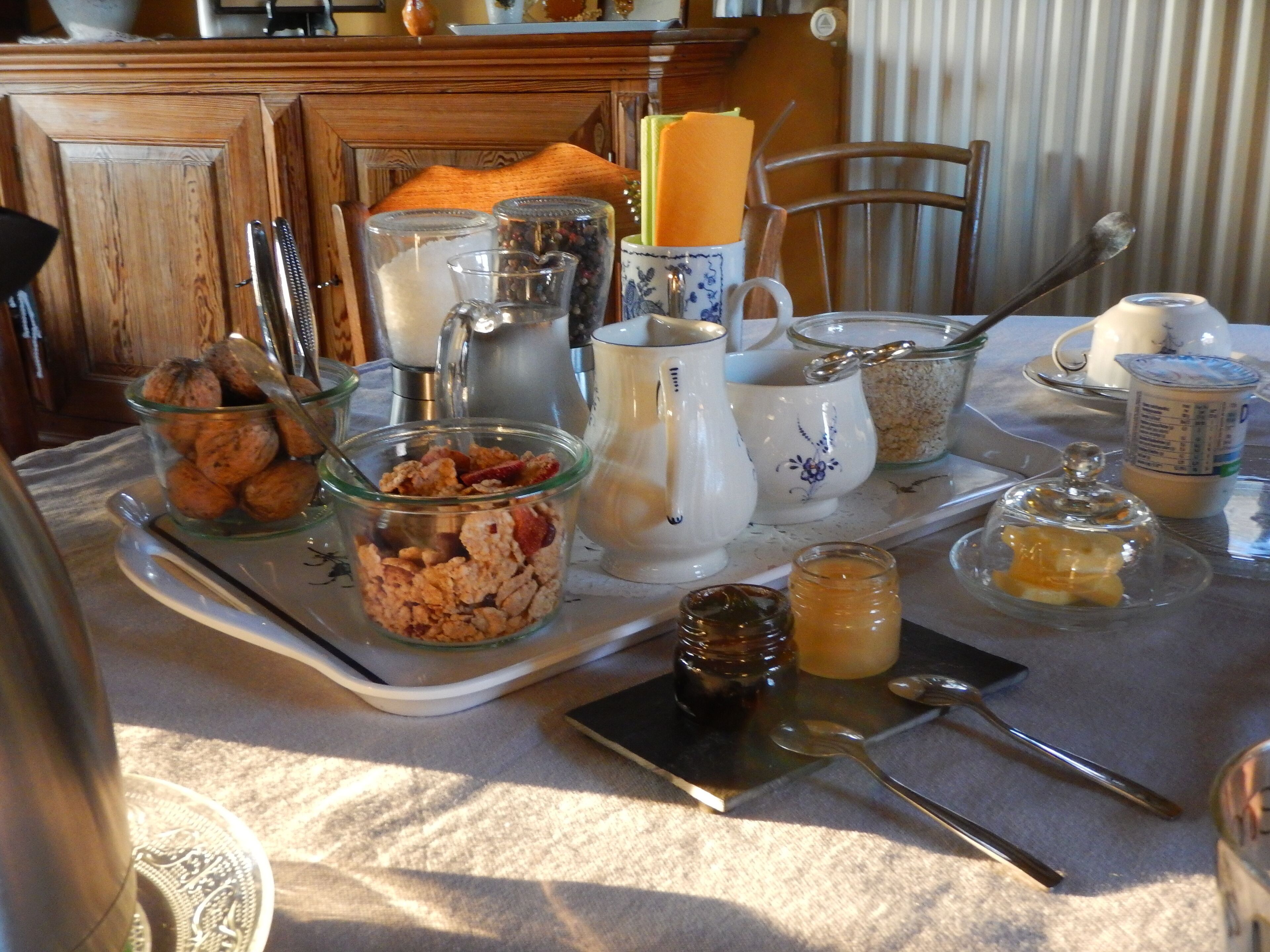A breakfast tray with various food items and utensils on a table.