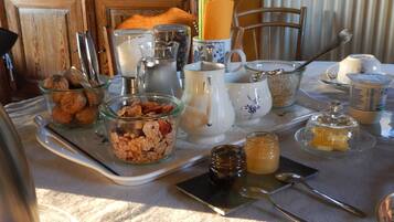 A breakfast tray with various food items and utensils on a table.