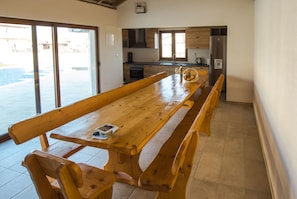 Enjoy dining or socializing around the large table and benches in this well-appointed room.