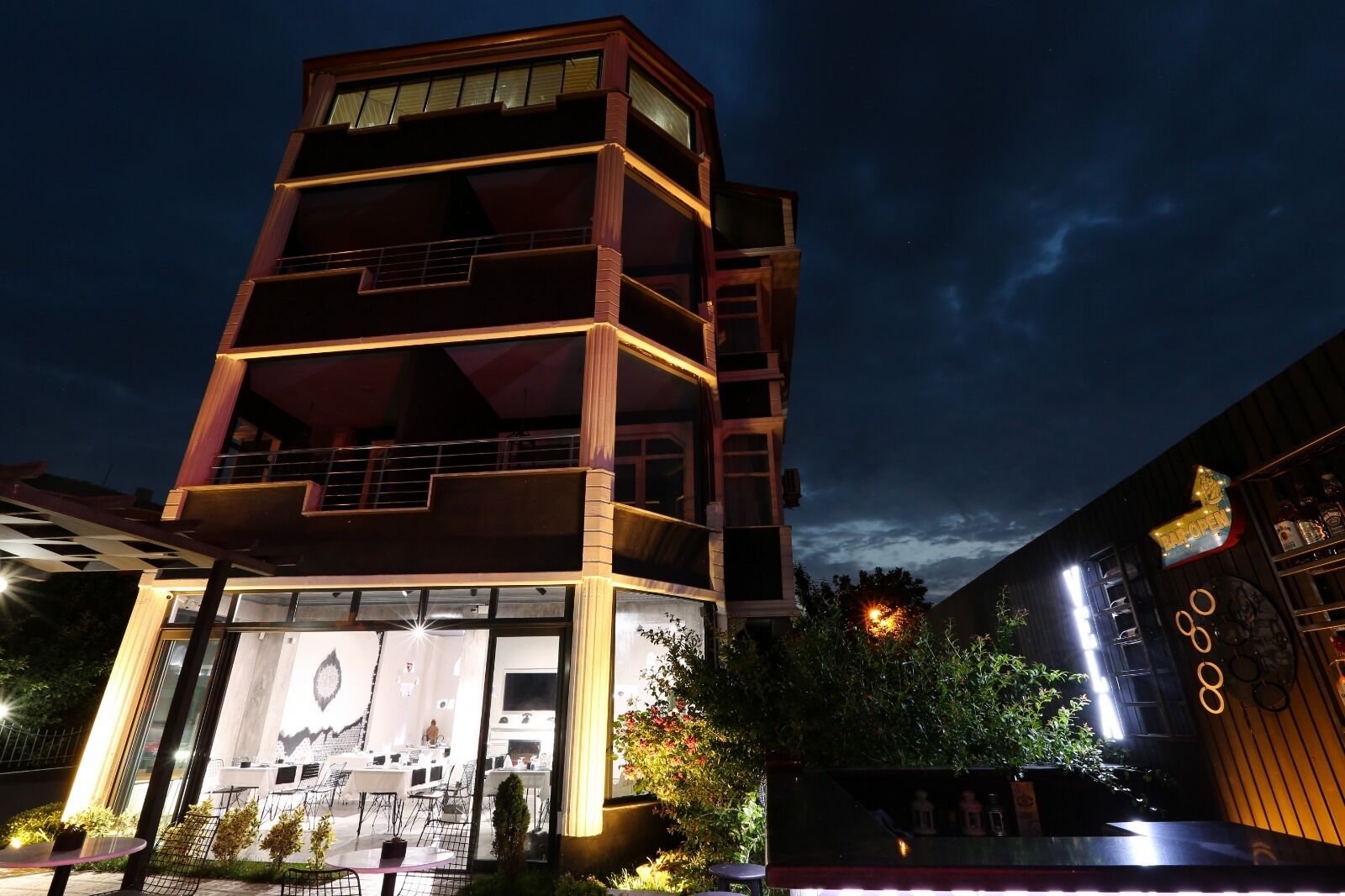 Un edificio de varios pisos con balcón y zona de estar al aire libre.