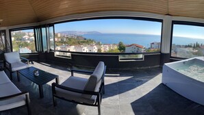 A balcony with a view of the sea, a hot tub, and seating area. - No57 Suites (Sinop)