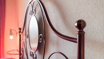 A metal bed frame with a round headboard and a decorative finial.