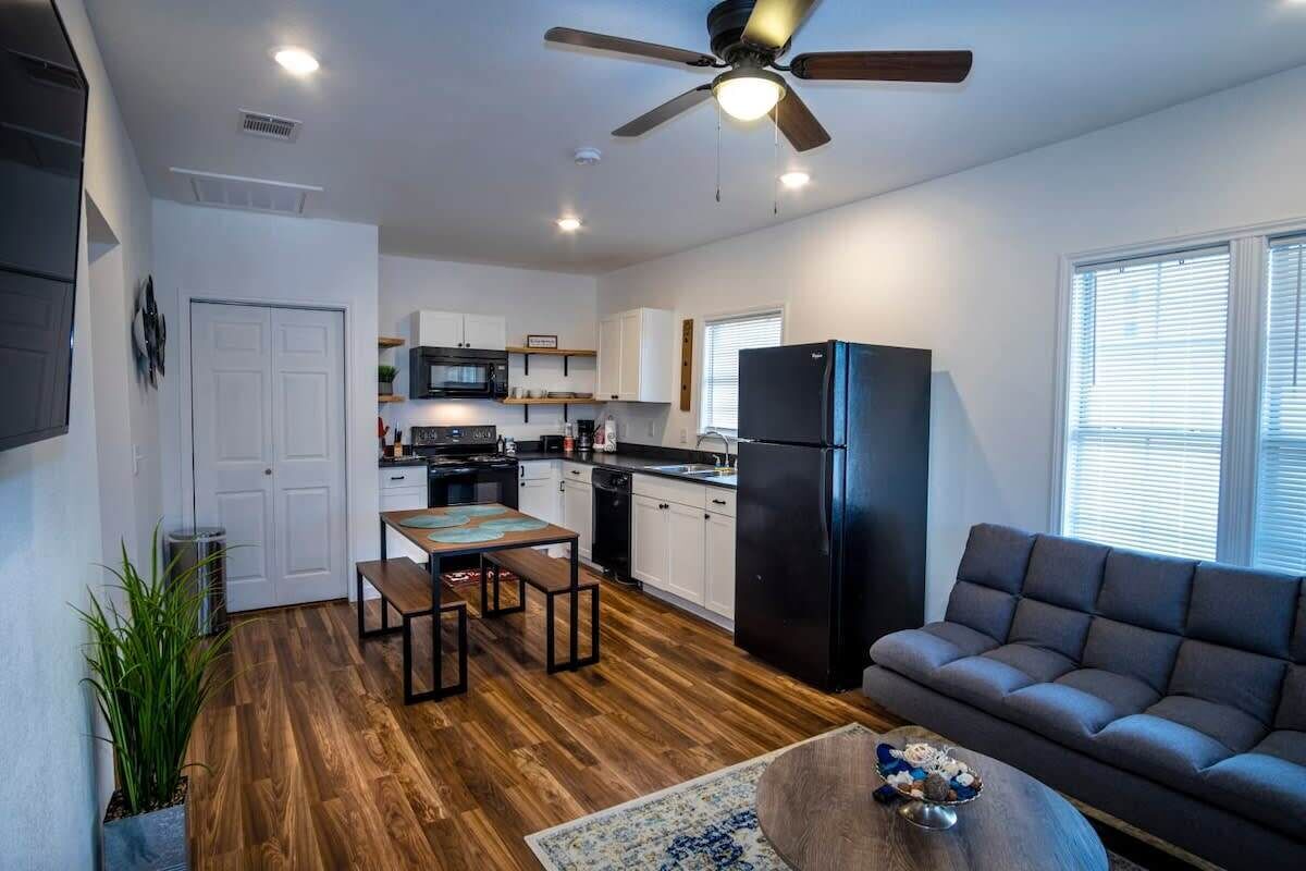 A modern apartment with a kitchen, dining area, and living room.