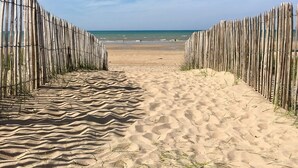 A sandy beach path leading to the sea, flanked by wooden fences. - Fully renovated apartment with direct sea access (100m) 2nd floor elevator (Cabourg)