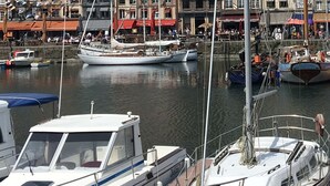 A marina with boats docked, a clear sky, and historic buildings in the background. - Fully renovated apartment with direct sea access (100m) 2nd floor elevator (Cabourg)