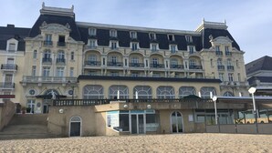 A large, historic hotel with multiple balconies and a grand entrance. - Fully renovated apartment with direct sea access (100m) 2nd floor elevator (Cabourg)
