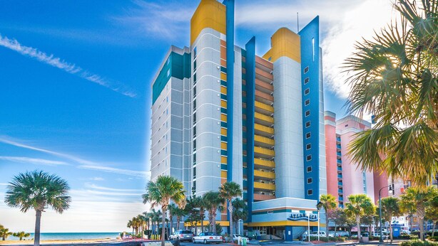 A multi-story hotel with a modern design, featuring balconies and a beach view. - Atlantica 757 (Myrtle Beach)