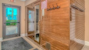 An entrance with an exit sign, a notice about supervision, and a coat rack. - The Palace 1702 (Myrtle Beach)
