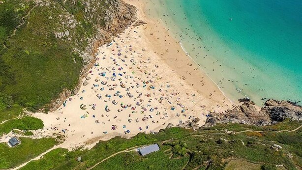 An aerial view of a coastal area with a sandy beach, clear turquoise waters, and a small rocky island. - 1bed Cottage Sleeps 2 - Enclosed Garden, Pets, Bbq (Helston)
