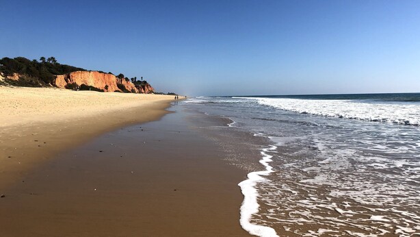 A beach with a sandy shore and a cliff in the background. - Space and comfort in beautiful Vilamoura, Algarve, Portugal  (Vilamoura)