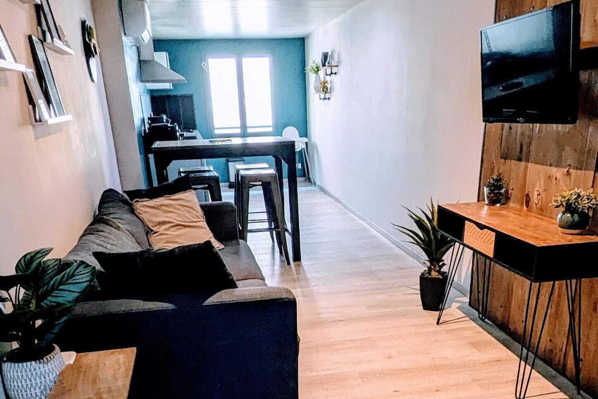 A modern living room with a sofa, coffee table, and TV.