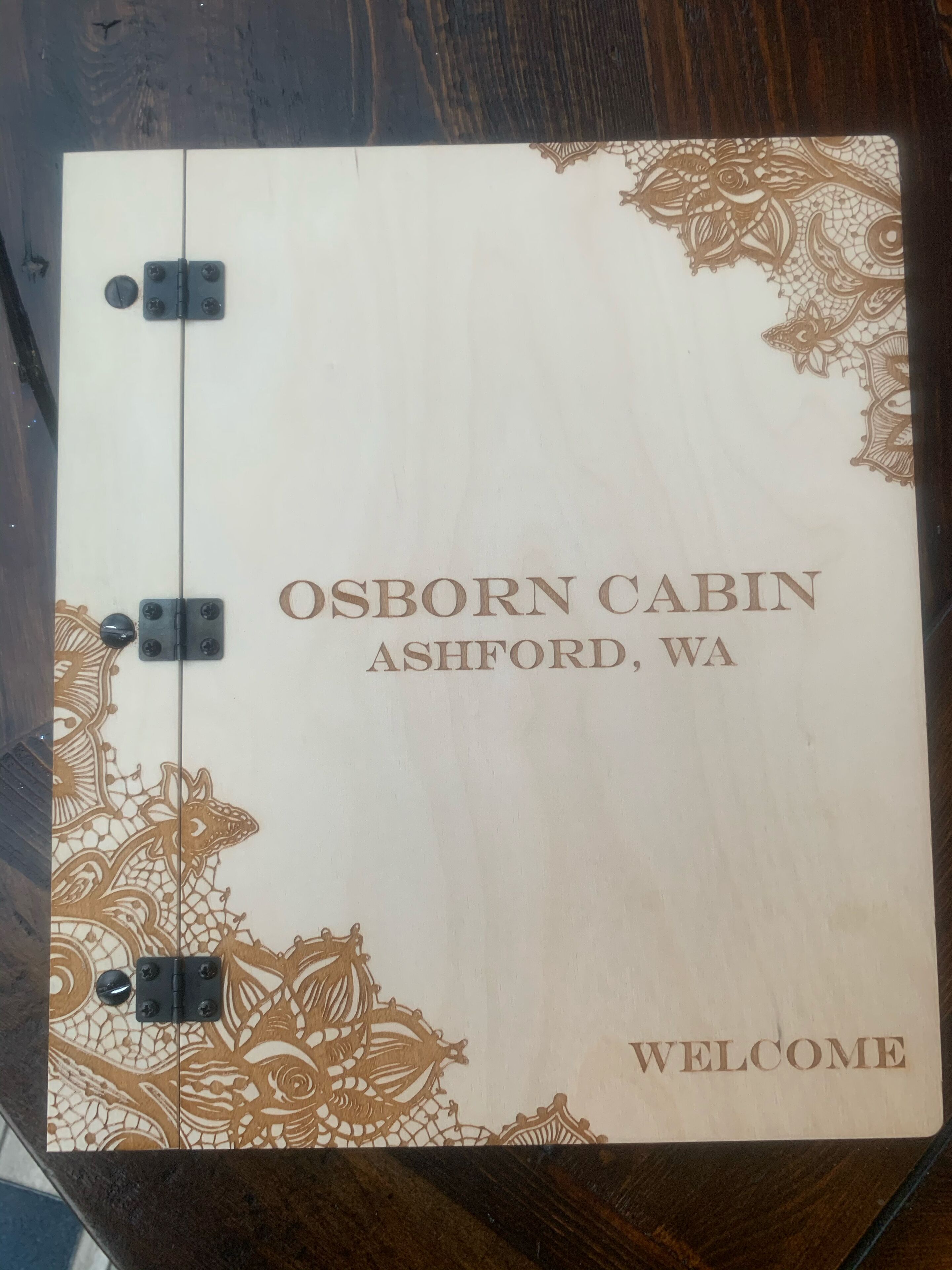 A welcome sign for Osborn Cabin in Ashford, WA.