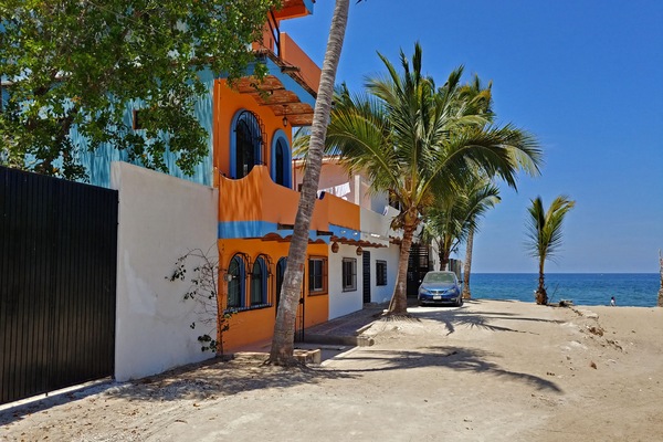 The Faro is the second and third floors of the orange building and at the beach.