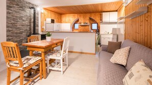 A cozy cabin interior with a dining area, kitchen, and living space. - Stunning private villa for 4 guests with WIFI, TV, patio and pets allowed (Armeno)