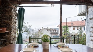 A wooden table set for two with plates, cutlery, and a potted plant. - Stunning private villa for 4 guests with WIFI, TV, patio and pets allowed (Armeno)
