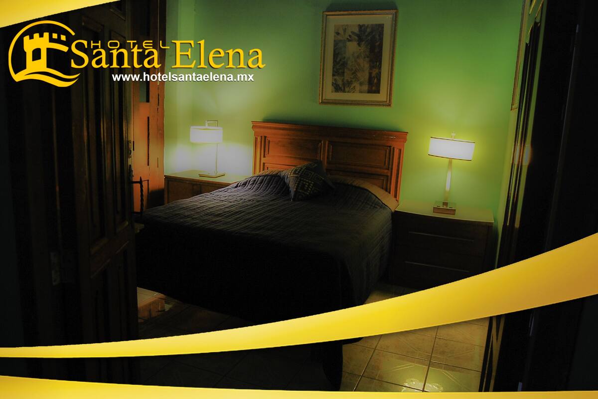 A hotel room with a bed, nightstands, and lamps.