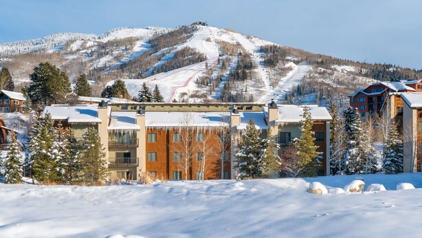 A snow-covered mountain with a ski resort in the background. - Charming Studio + Loft Condo | Walk to Gondola | Pool, Hot Tubs and Views! (Steamboat Springs)