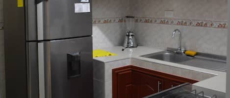 Fridge, coffee/tea maker, cookware/dishes/utensils