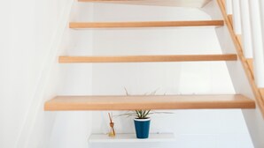 A staircase with wooden steps and white railings. - Pico Rubia, two bedroom apartment, living room, kitchen and bathroom (Ampuero)