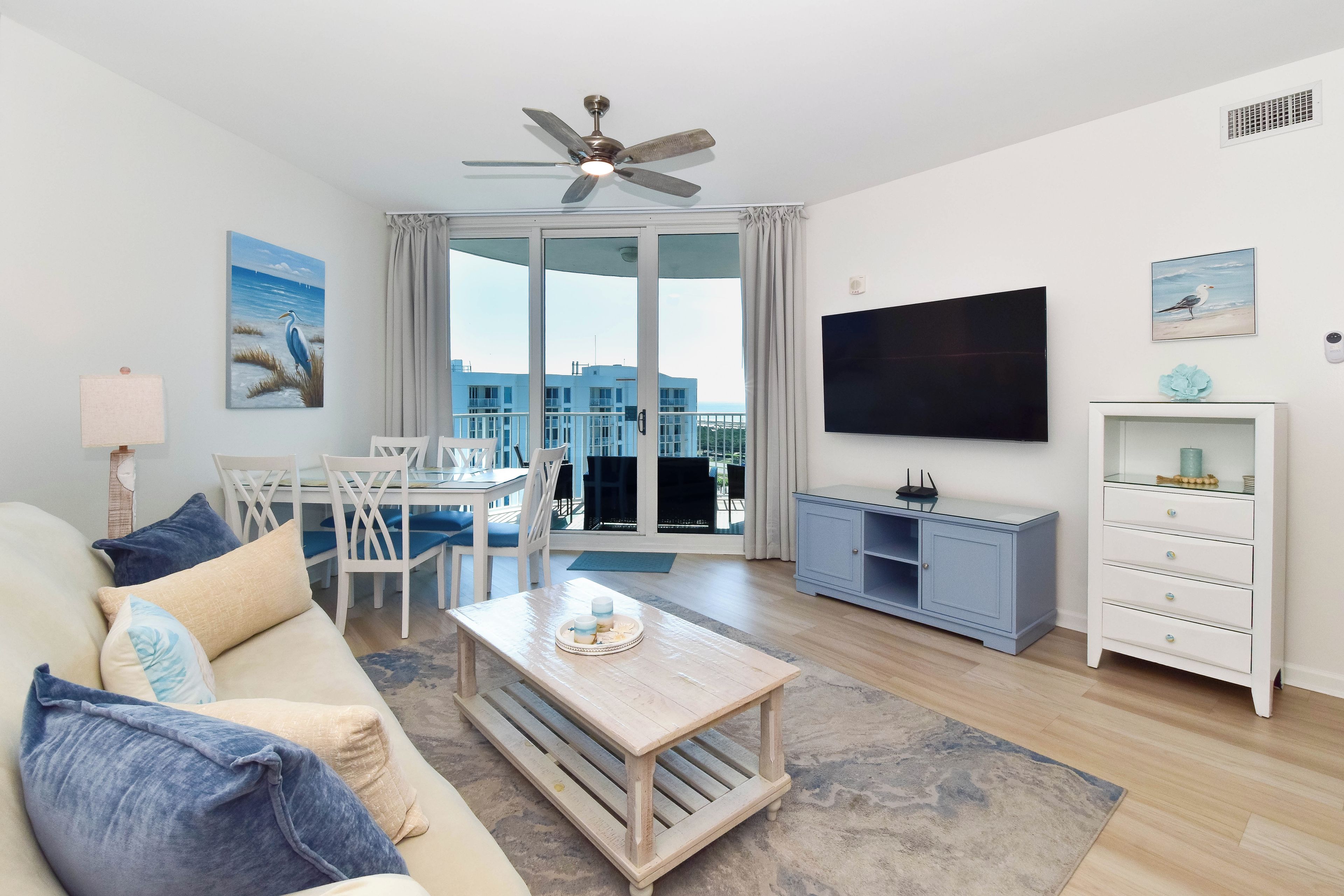 A modern living room with a sofa, coffee table, and a flat-screen TV.