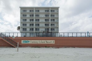 A multi-story building with a sign reading 'Fantasy Island Resort II' on the ground floor.