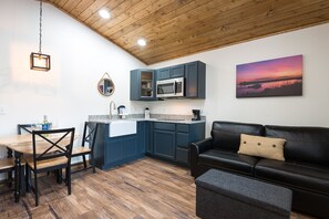 Cabane Deluxe | Coin séjour | Tél évision de 50 pouces avec chaînes par satellite, cheminée, livres