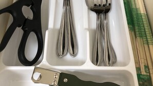 A drawer containing a pair of scissors, three forks, a spoon, and a bottle opener. - Sapporo Apartment 105 (Sapporo)