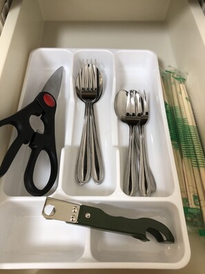 Kitchen essentials at your fingertips, including scissors, a bottle opener, and utensils.