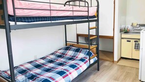 A bunk bed with a desk and a small kitchenette. - Sapporo Apartment 1 (Sapporo)