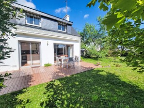 A modern two-story house with a patio, sliding glass doors, and a garden. - Ty Mam Goz by Interhome (La Trinité Sur Mer)