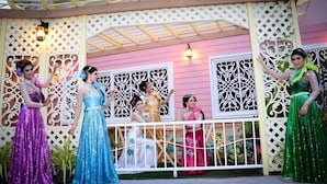 A stage with a decorative backdrop and a white railing. - Grand Visanu Hotel (Nakhon Sawan)