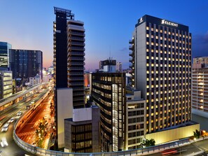 A modern hotel with a prominent 'ELCIENT' sign, surrounded by high-rise buildings and a busy highway. - HOTEL ELCIENT OSAKA UMEDA (Osaka)