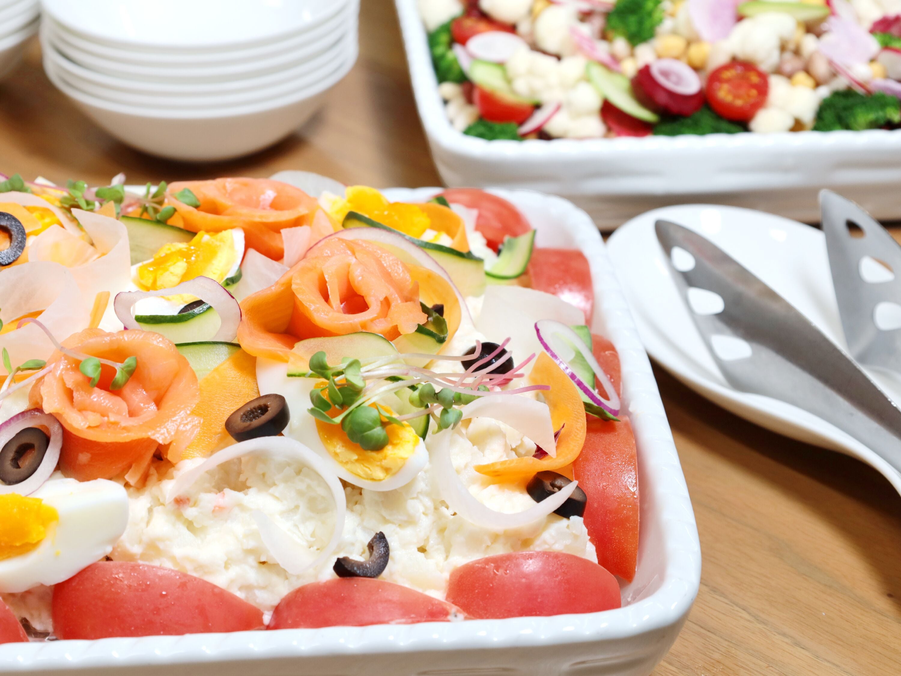 A tray of food with various ingredients like salmon, eggs, and vegetables.